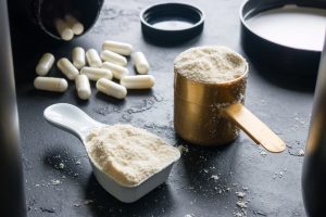 measuring spoons with sports supplements and capsules