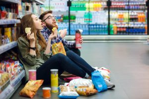 couple eating junk food in convenience store